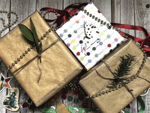 Two gifts wrapped in brown paper and one with colourful paper
