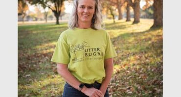 Blonde woman wearing a lime green T-shirt.