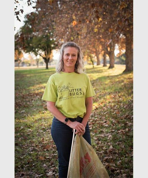 Blonde woman wearing a lime green T-shirt.