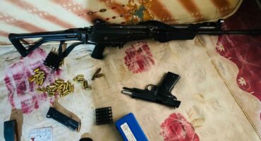 a rifle, pistol and gamazines and live ammunition