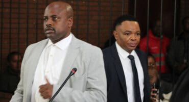 two men enter the court dock