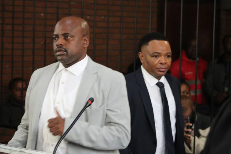 two men enter the court dock