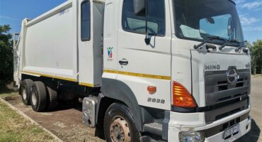 a white compactor truck