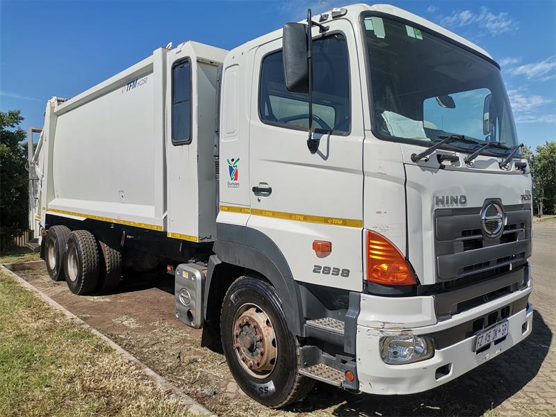 a white compactor truck