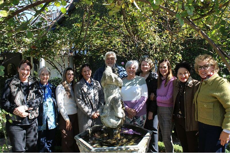 Group of people standing around a water feature