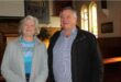 Elderly woman and man standing next to each other