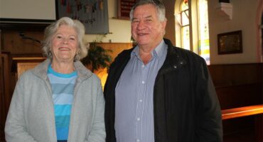 Elderly woman and man standing next to each other