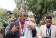 An elderly man in traditional regalia