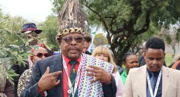 An elderly man in traditional regalia