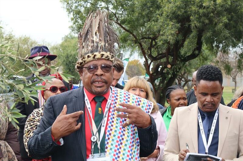 An elderly man in traditional regalia