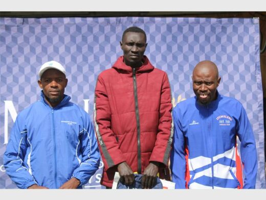 Three men standing on the podium