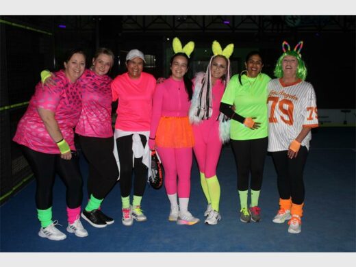 a group of women in colourful outfit  