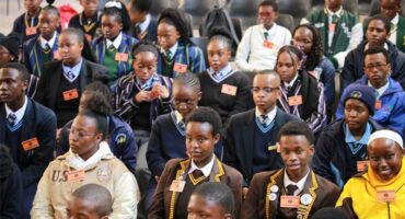 A hall full of learners taking part in a spelling bee.