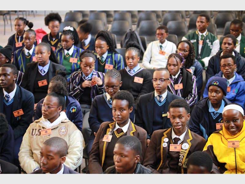 A hall full of learners taking part in a spelling bee.