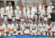 Group of people wearing karate gi's and wearing medals