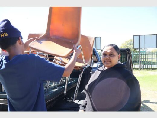 a man a woman loading chair onto a bakkie