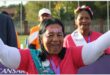 a woman dressed in pink costume celebrating