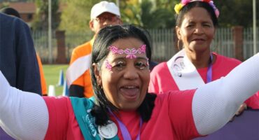 a woman dressed in pink costume celebrating