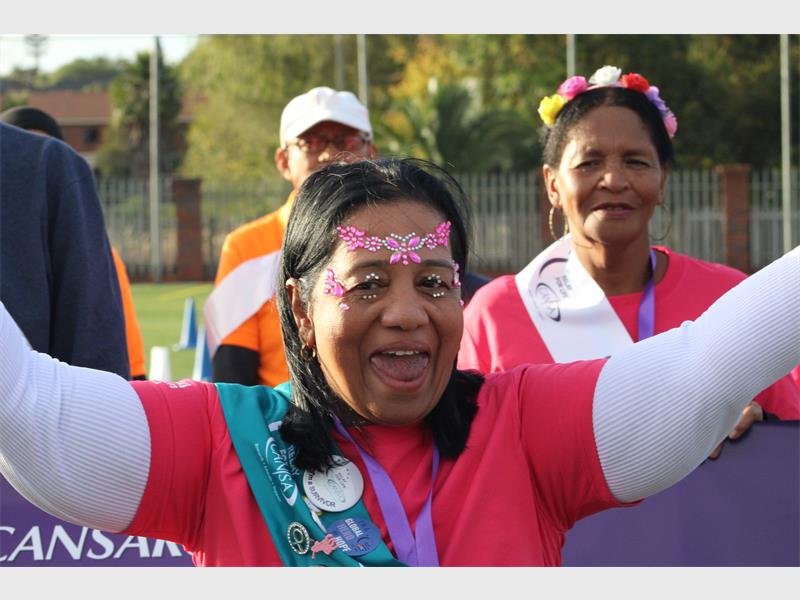 a woman dressed in pink costume celebrating