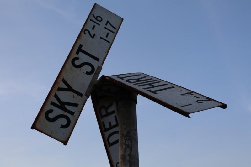 Street name signs mounted on a pole along Sky Street in Cason