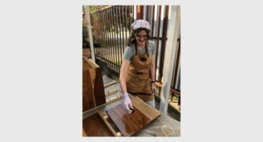 A young woman doing woodworking.