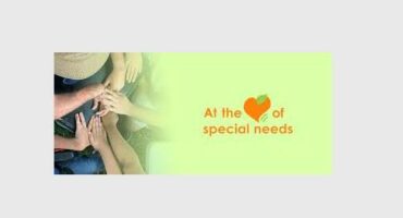 Image of hands on green background with text reading: at the heart of special needs