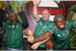 three men in bafana bafana shirts