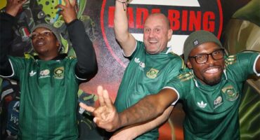 three men in bafana bafana shirts