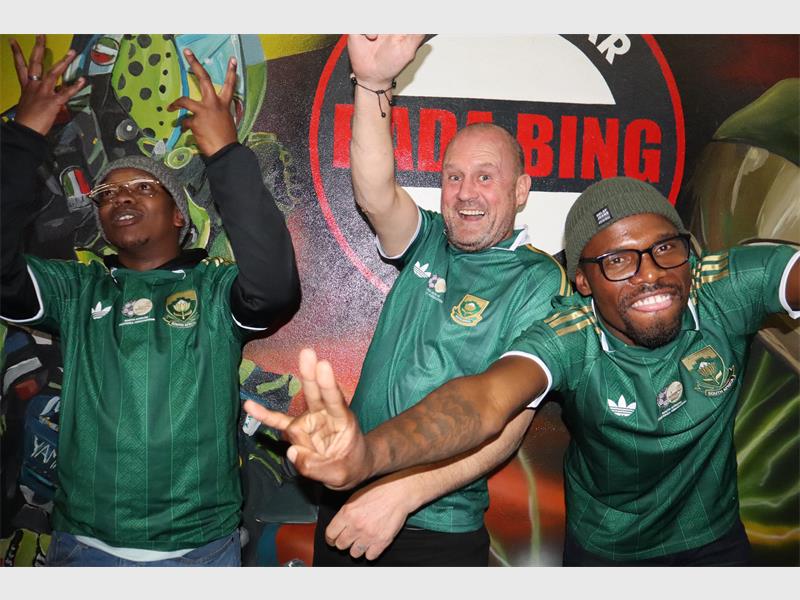 three men in bafana bafana shirts