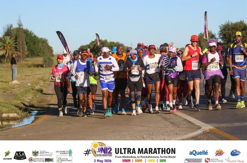 A group of runners from various clubs lining up at the start of the Comrades Marathon.