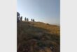 A view of Melville Koppies with a group of hikers against a blue sky.