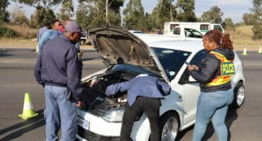 police officers inspecting a motor vehicle