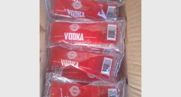 Bottles of vodka in a box photographed from above.