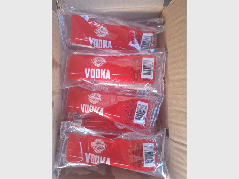 Bottles of vodka in a box photographed from above.