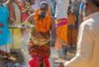 Man in Hindu attire walking over coals
