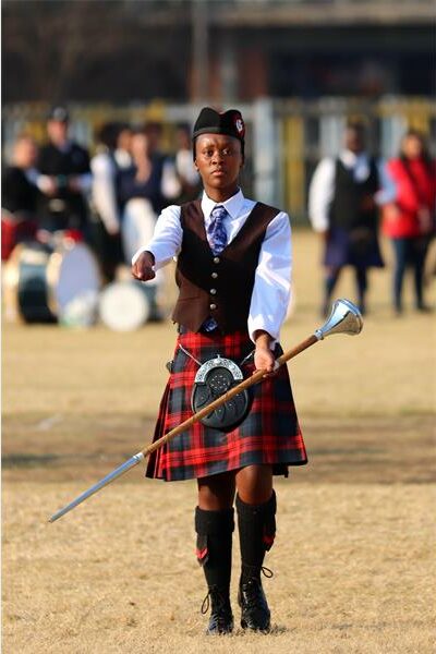 Black girl marching holding a silver mace