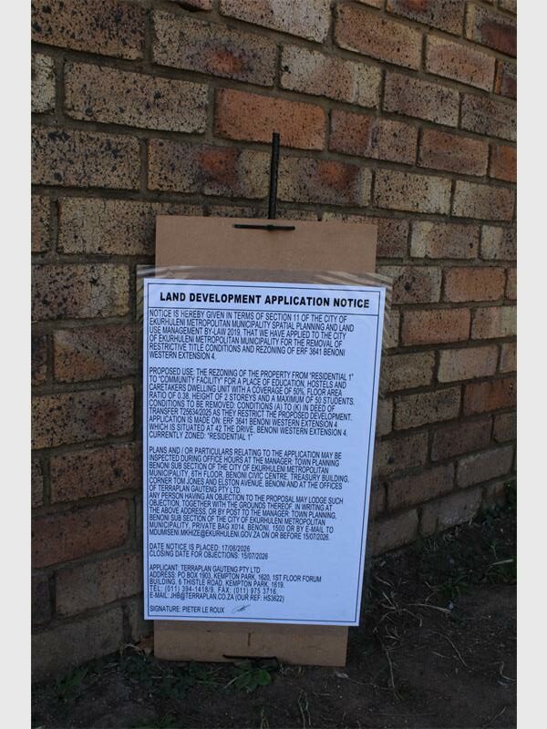 A council notice stuck to a brick wall.