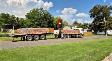 A view of a truck transporting bricks parked in a residential suburb.