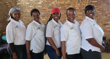 a group of women in white t-shirts
