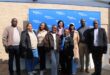 Group of people standing in front of a blue Eskom banner