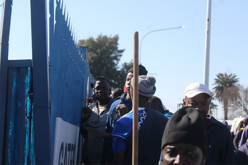 Marchers standing in front of palisades.