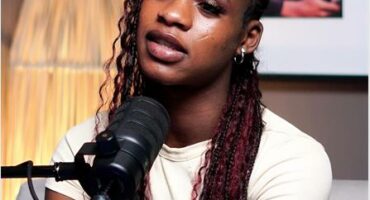 a woman with brown braids and a white top.