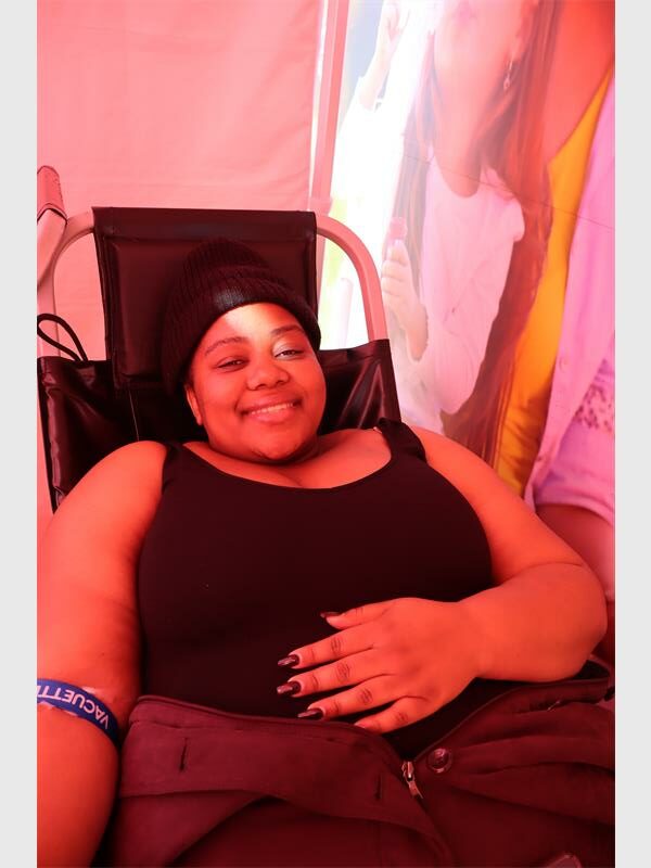 A black woman donating blood.