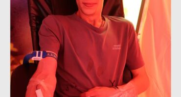 A young white male donating blood.