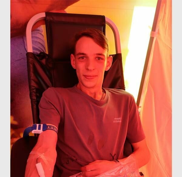 A young white male donating blood.