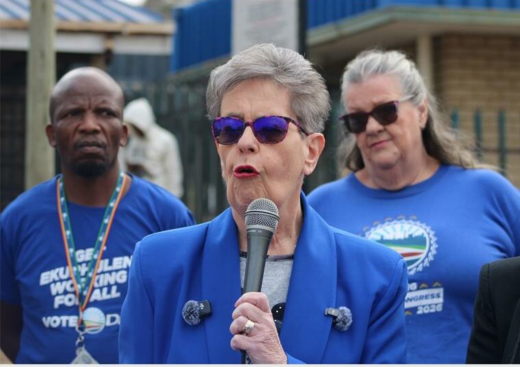 two women and a man in blue political regalia