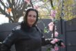 Woman posing next to a flower garland