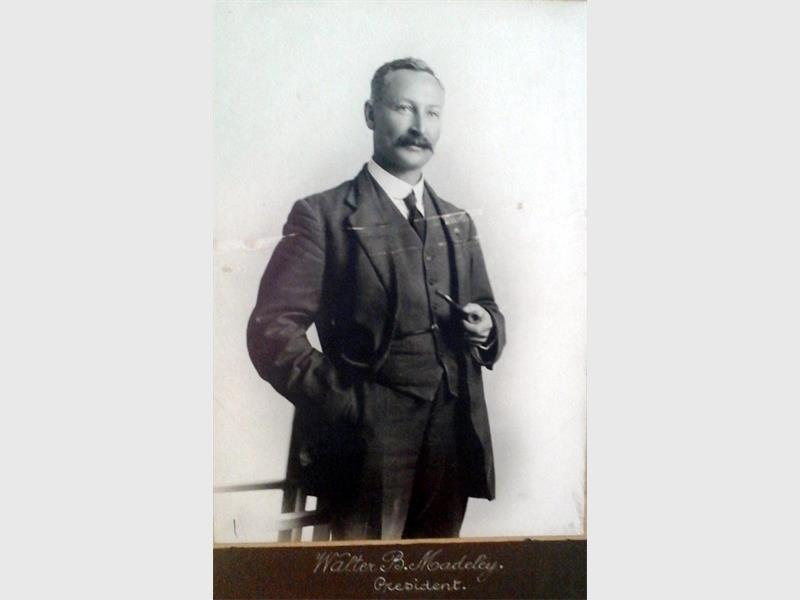 A black and white image of a man dressed in a suit and waistcoat with moustache.