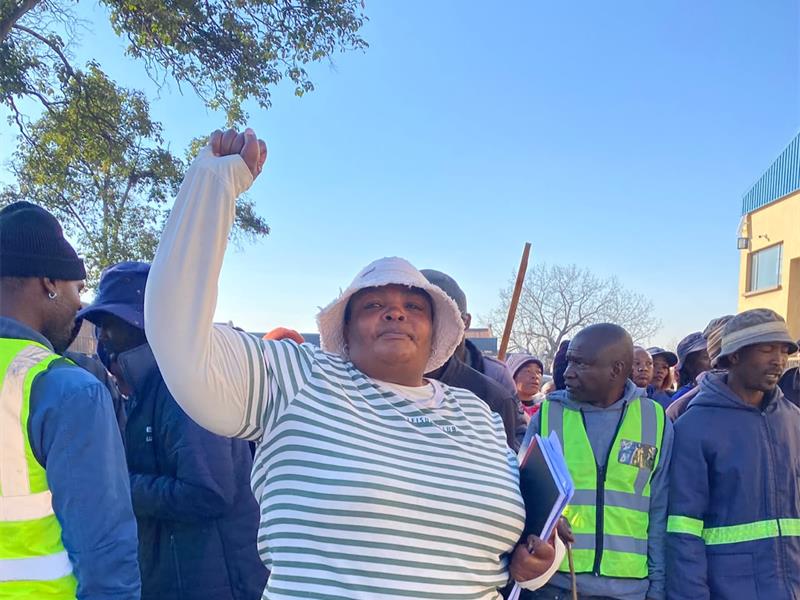 Black woman hold her right fist in the air