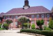 A front view of Willowmoore High School with gardens in the foreground.